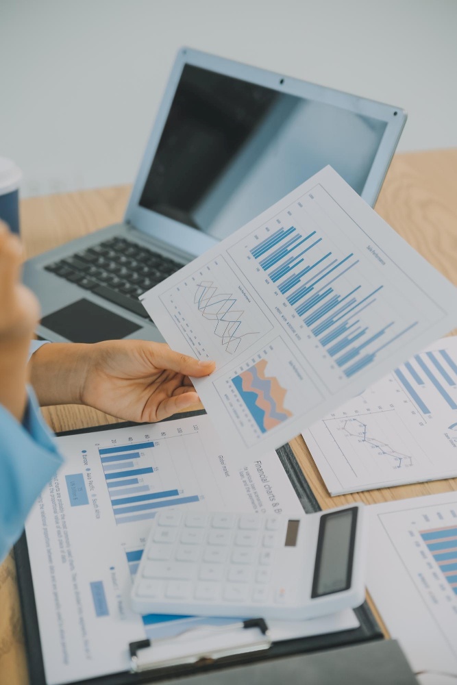 Financial reports being studied by one person at a desk